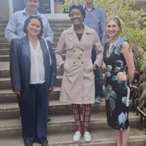 Dr Shenika McFarlane Morris and colleagues from the Department of Education on stairs